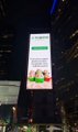 A nighttime cityscape displays a brightly lit digital billboard with the green and white "PUMP" logo featuring a cartoon mascot, referencing the Pump.fun memecoin platform referenced in the post. The image illustrates the visibility of the Pump.fun brand being critiqued for maintaining a strong public presence despite traders rotating away from its newer token pairs toward attention-grabbing IP-based coins.