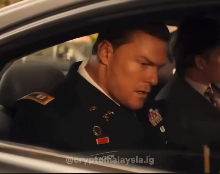 The image features a man dressed in military uniform, sitting inside a car with his head down. He appears to be looking at something outside of the vehicle or possibly thinking about something. The caption above the image reads "When you realize why it's called Crypto and not Laughto:". This suggests that there might be some connection between the man's attire and the term "Crypto" in the context of the image, but further information is needed to determine the exact reason behind this association.