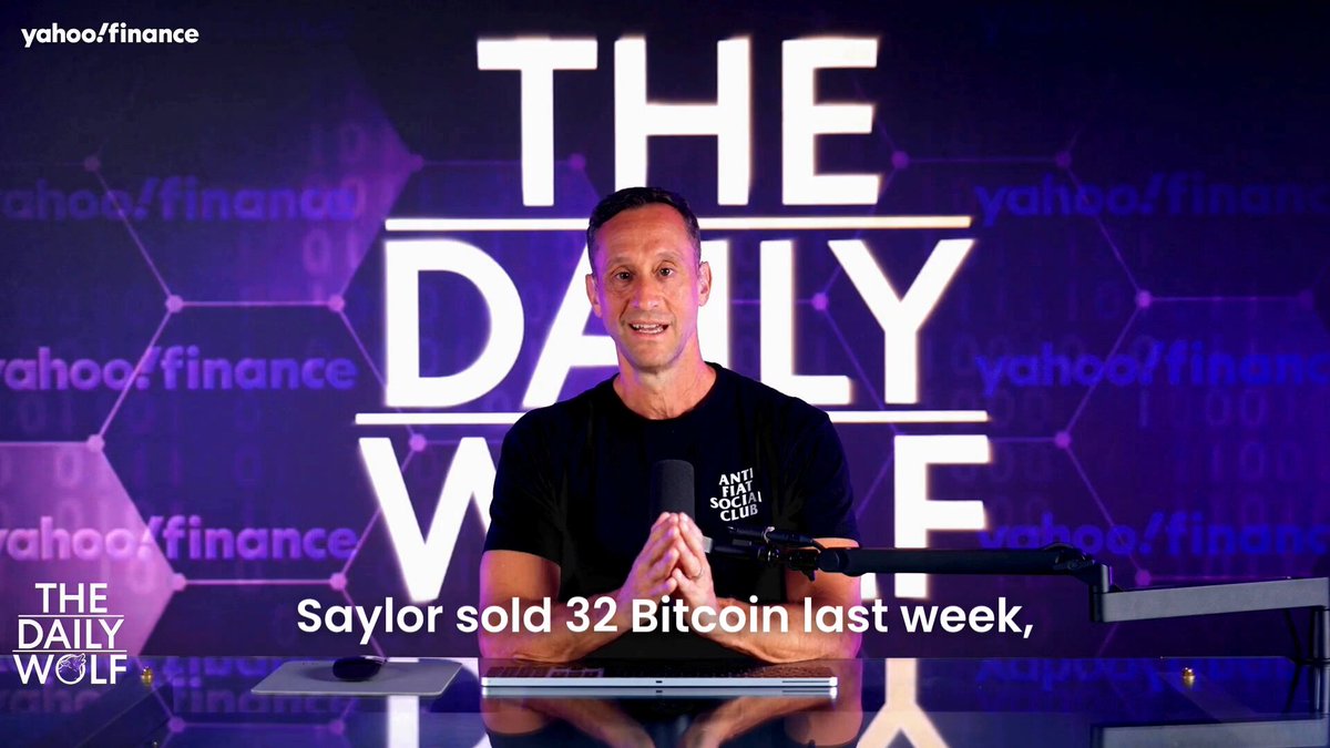 The image features a man sitting behind a desk with a computer and keyboard in front of him. The backdrop of the scene has a large purple screen displaying the text "Daily Wave" with the man's name prominently displayed at the top. At the bottom right corner, there is an additional piece of text that reads: "I bought STRC around $92 and Bitcoin at $60,000 because it seemed like the most obvious counter trade in history". The main focus of this image is on the man who appears to be discussing or evaluating a particular situation related to Bitcoin.