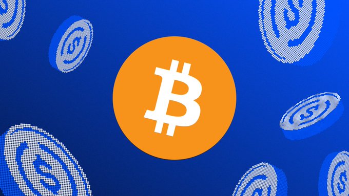 A graphic displaying the Bitcoin logo (orange circle with white 'B') against a blue background with smaller patterned Bitcoin coin icons.