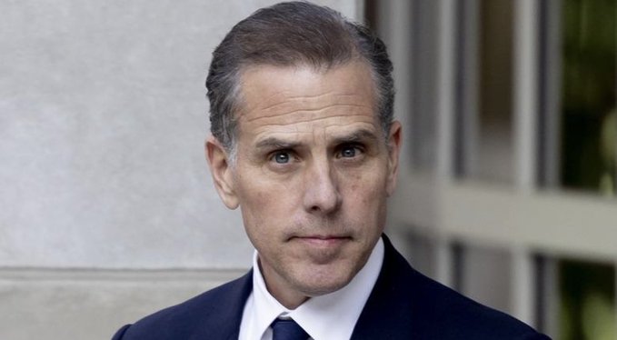 A portrait of a man in a dark suit and white shirt with a serious expression.