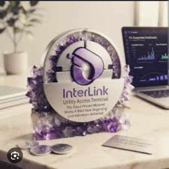 A promotional display featuring a clear globe filled with amethyst clusters, branded with 'InterLink Utility Access Terminal' and text about 'The Social Media Manner' and 'Marks A Bold New Beginning', set on a desk with a laptop in the background.