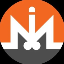 A circular logo with an orange top half and gray bottom half features a stylized white 'M' with a phallic design in the center.
