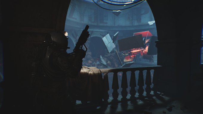 A dark, atmospheric video game screenshot shows a character in tactical gear aiming a weapon at floating debris illuminated by a red light.
