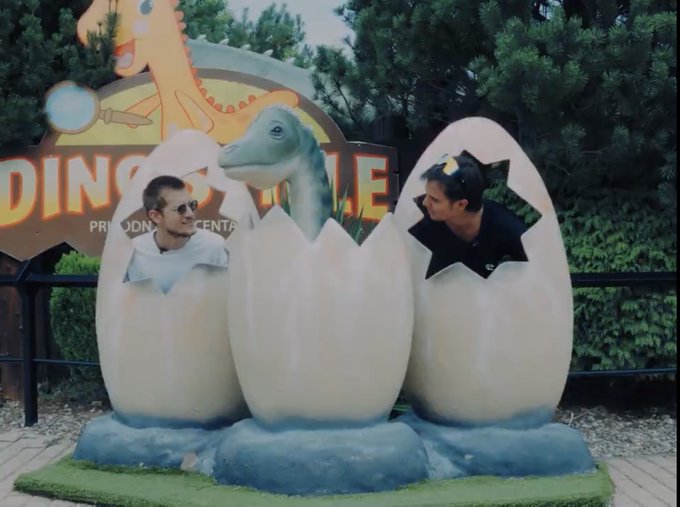Two people pose playfully inside a dinosaur-themed "hatching egg" photo cutout at "Dinosaur Park Průhonice," as a cartoon raptor peers between them. The whimsical, meme-style image humorously supports the post's claim of bringing a "new asset class" to the Solana ecosystem, echoing the playful "dino" culture often associated with Solana's branding.
