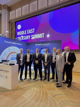 A group of seven men in suits poses together at the "Middle East Treasury Summit" conference, with branding for Ripple Treasury and "Future-ready Treasury" visible on the backdrop, aligning with the post about Ripple Treasury's two-day event in Dubai.