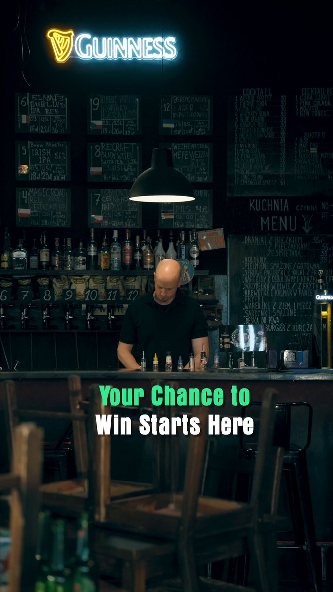 The image features a man sitting at a bar with a Guinness sign behind him. He appears to be playing a game of pool or snooker while wearing a black shirt, bald head, and glasses. The pub has a green neon sign that reads "Your Chance 10 Win starts here". There are several bottles on the table in front of the man, indicating he is likely enjoying some drinks as well.