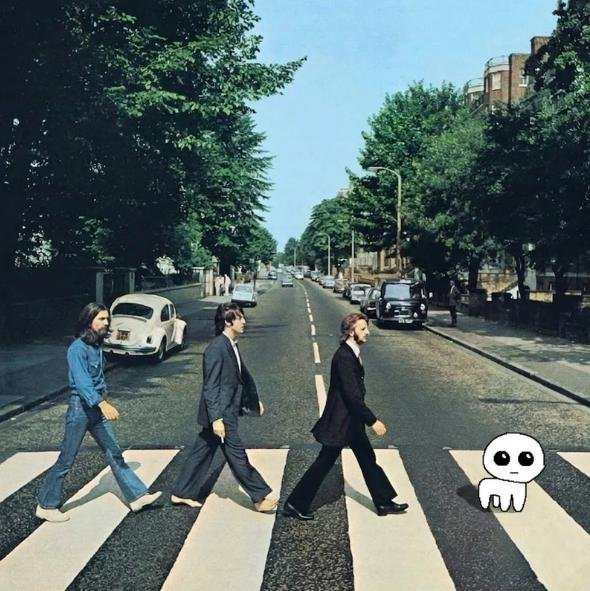 A recreation of the iconic Beatles Abbey Road album cover features a man in a denim outfit, a man in a gray suit, and a man in a black suit walking across a zebra crossing, followed by a small white cartoon character with large eyes.