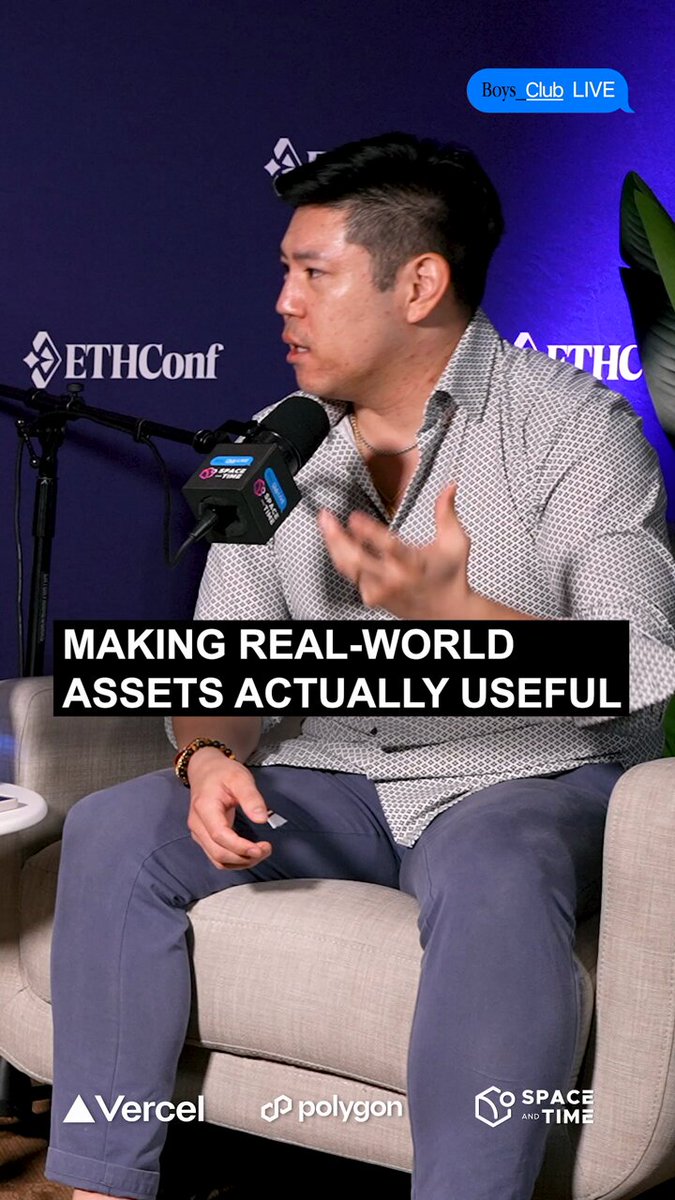 The image features a man sitting in a chair, talking into a microphone during an event or conference. The text "Making real-world assets actually useful" can be seen in the image as well. This suggests that the man might be discussing how to make use of various types of assets and their practical applications in the real world.
