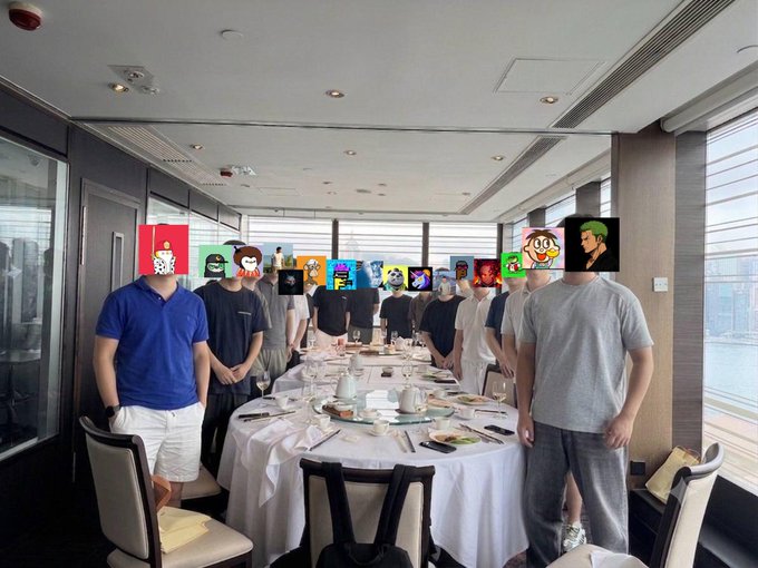 A group of men gathered around a circular dining table in a high-rise restaurant, their faces obscured by various cartoon stickers and emoji-like images. The accompanying text humorously suggests the logos were covered to avoid "unnecessary misunderstandings," though the image itself shows no visible branding—implying the edit was preemptive discretion about the outing.