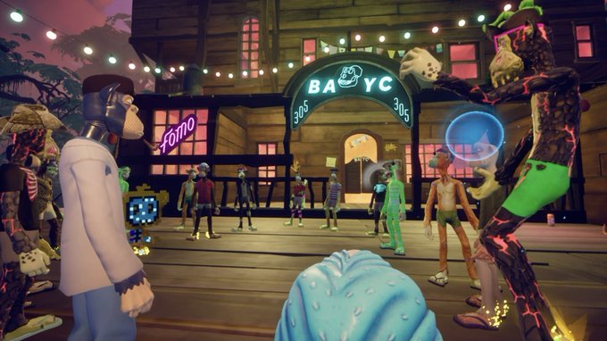 A screenshot from a 3D virtual environment (likely BAYC-related) showing various cartoonish avatars, including apes and other characters, gathered on a wooden deck in front of a building with a 'BAYC 305 305' neon sign and a 'Komo' storefront.
