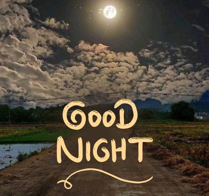 A nighttime landscape photo showing a full moon shining over a cloudy sky above a rural road, with stylized 'Good Night' text overlaid in cream-colored hand-drawn lettering.