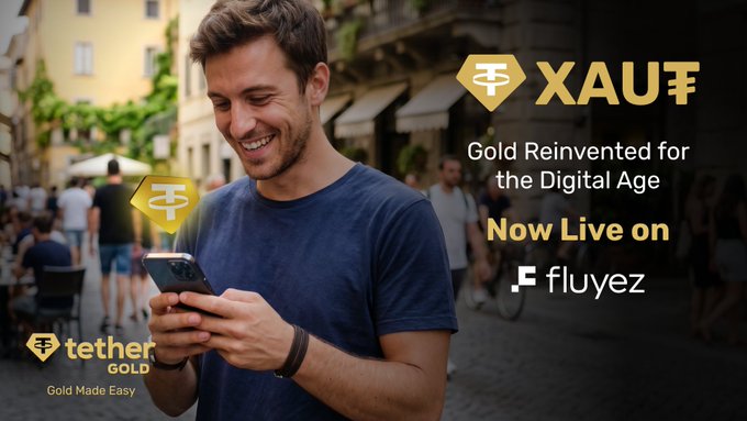 An advertisement for XAUT by Tether Gold, featuring a smiling man looking at his smartphone, with text reading 'Gold Reinvented for the Digital Age' and 'Now Live on fluyez'.