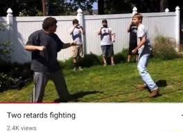 A low-quality video thumbnail titled 'Two retards fighting' with '2.4K views,' showing people in a grassy yard in front of a white picket fence.