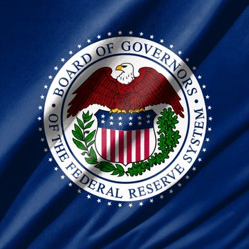 The image displays the official seal of the Board of Governors of the Federal Reserve System, featuring an eagle with a shield and olive branch, encircled by stars and the agency's name. This relates directly to the breaking news about the Federal Reserve proposing its GENIUS Act rules for stablecoin oversight, as the seal represents the governing body issuing these new regulatory requirements.