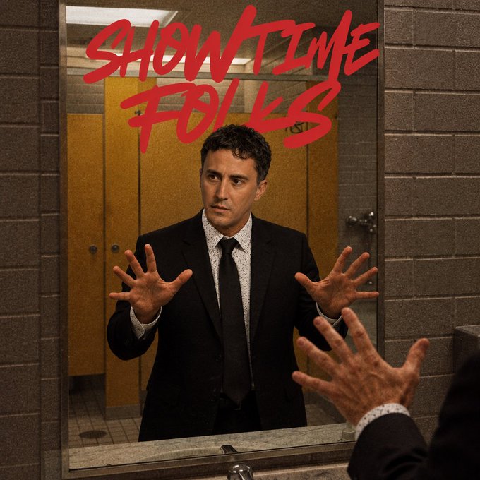 Promotional artwork for the TV series 'SHOWTIME FOLDS' featuring a man in a black suit and patterned tie staring intensely at his reflection in a public restroom mirror with his hands raised.