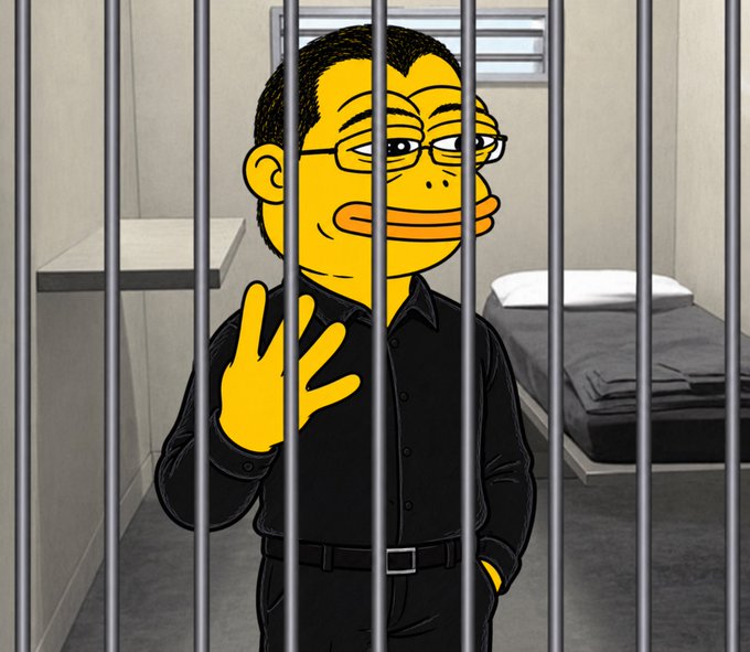 A Simpsons-style cartoon character resembling an Asian man with glasses, wearing a black shirt, standing behind prison bars with one hand raised in a jail cell.