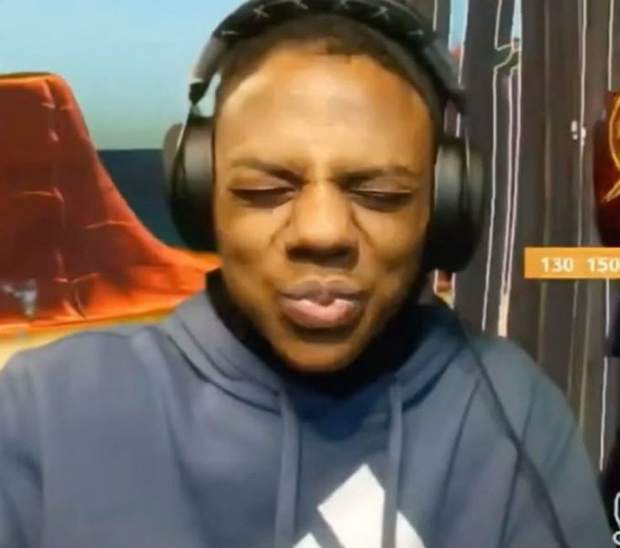 A reaction meme featuring a Black man wearing headphones and a dark hoodie, pursing his lips with a strained expression during what appears to be a livestream.