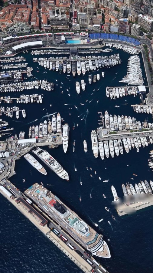 The image shows an aerial view of a large marina filled with numerous boats, including yachts and sailboats. The boats are docked at various points within the harbor, creating a bustling scene. In addition to the boats, there is also a cruise ship visible in the background. The post contains text that reads "Do you see what I see? An 'X' Not a common X That X $XRP". This message seems unrelated to the image and could be an error or a typo in the caption.