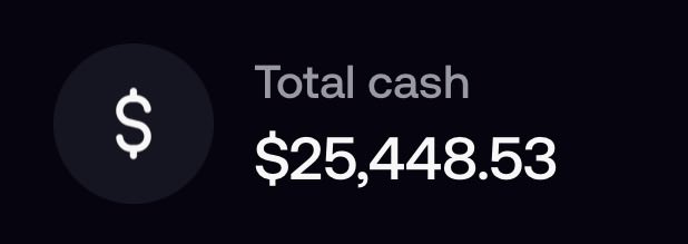 The image displays a dark-themed graphic featuring a dollar sign icon next to the text "Total cash $25,448.53," which appears to be a screenshot from a trading or brokerage account dashboard. It relates to the post's mention of a "$1k to $1m" trading journey, showcasing the current cash balance as a milestone or progress update in the creator's public trading challenge.