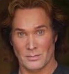 A man with shoulder-length wavy blonde hair gazes confidently at the camera with a subtle smile, embodying the bullish spirit of the "gm bulls" greeting with his strong, optimistic presence.