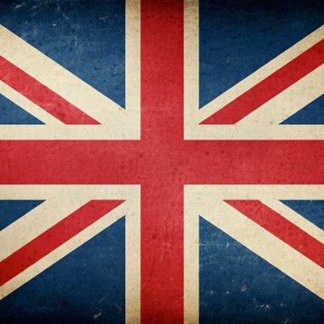 A weathered Union Jack flag fills the frame, its distressed texture symbolizing Britain in the context of a violent home invasion in Solihull, where masked men attacked a British couple and forced a crypto transfer.