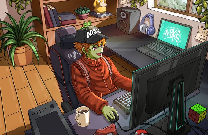 A green-skinned cartoon character wearing a "MB&YC" cap sits at his gaming setup with a laptop and monitor displaying "MB&YC" logos, surrounded by plants and gaming accessories like a Rubik's cube and headset. The cozy, vibrant scene captures a cheerful morning gaming vibe that matches the upbeat "Good morning my friends" greeting.