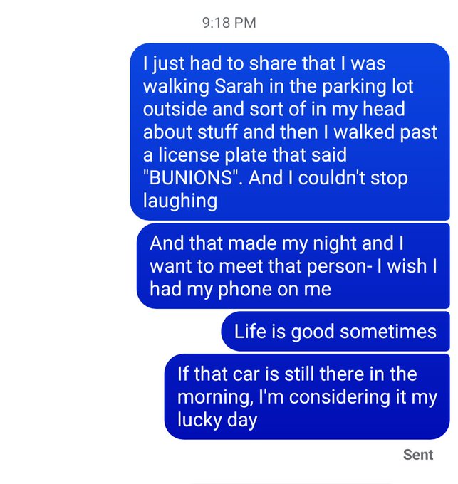 A screenshot of a text message conversation dated 9:18 PM in which a sender expresses amusement about seeing a car license plate that reads 'BUNIONS' while walking in a parking lot.