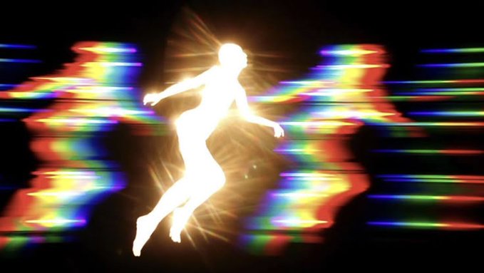 A glowing, silhouetted figure floating against a black background with colorful, glitch-like horizontal streaks of light.