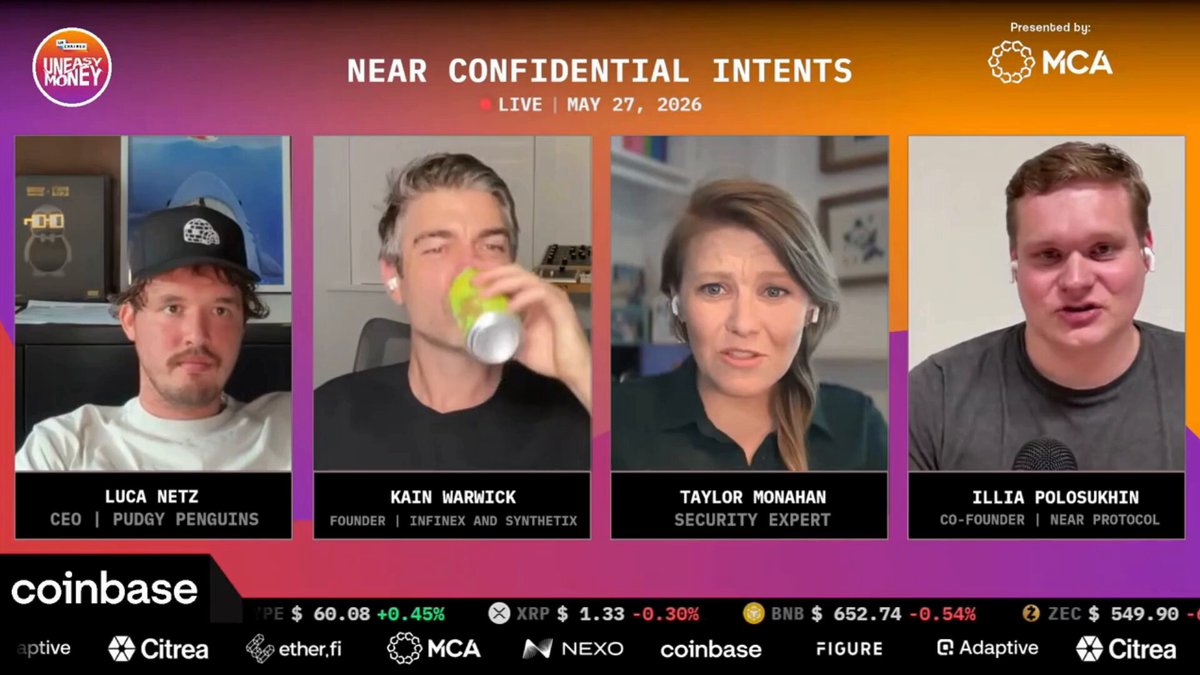 The image shows a group of four people sitting around a table, with one person drinking from a can while others look on or engage in conversation. The background features a purple and orange color scheme, which complements the overall theme of the image. The caption below the image reads "Near Confidential Intentions", suggesting that this gathering might be related to a private event or discussion involving sensitive information.