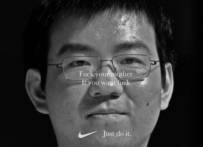 A black-and-white close-up of an Asian man wearing glasses appears as the face of a defaced Nike "Just Do It." ad, where the original slogan has been replaced with the crude phrase "Fuck your mother / If you want fuck" — used to mock a $50K trading challenge promo by repurposing the iconic "Just Do it." tagline in insulting fashion.