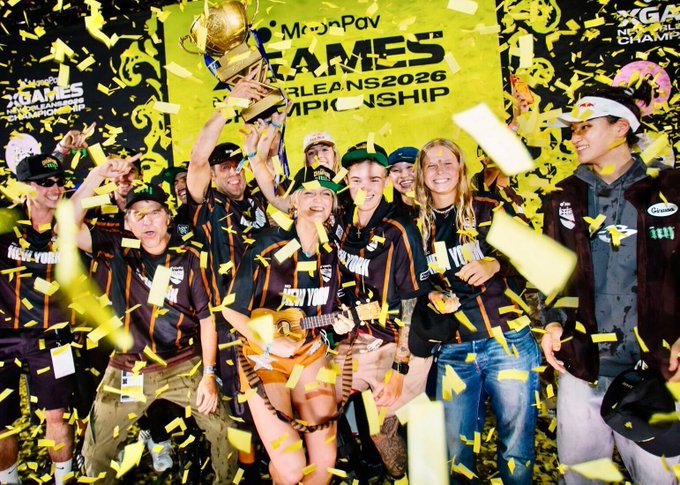 XC New York team members celebrate their championship victory, hoisting a gold trophy amid a shower of yellow confetti at the MoonPay X Games New Orleans 2026 Summer Championship.