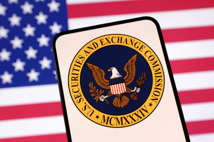 A photo of the U.S. Securities and Exchange Commission (SEC) seal displayed on a smartphone screen, set against a background of the American flag.