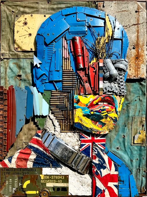 Mixed media artwork of a figure with a blue head, featuring a colorful face, constructed from recycled materials, machinery parts, and a British Union Jack flag on the chest.