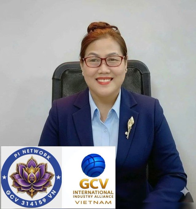 The image features a woman wearing glasses sitting behind a desk or chair. She has a smile on her face as she poses for the photo. The background of the image shows a white wall, which contrasts with the blue logo that reads "GCV" in front of her. This logo is associated with the International Industry Alliance and Vietnam.