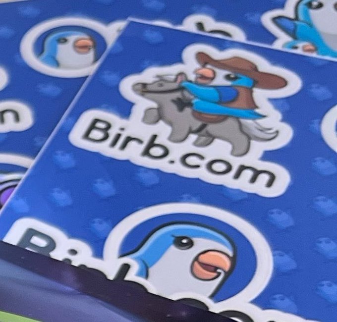 Blue stickers featuring a cartoon blue bird mascot, including one design showing the bird as a cowboy riding a horse with the text 'Birb.com'.