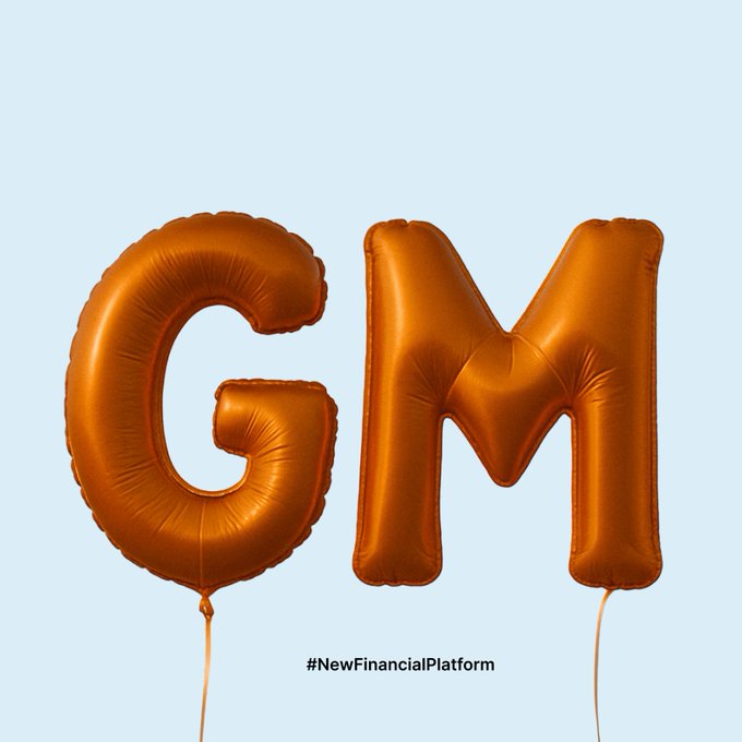 Two shiny bronze-colored foil balloons shaped like the letters 'G' and 'M' are displayed against a light blue background with the hashtag '#NewFinancialPlatform' below.