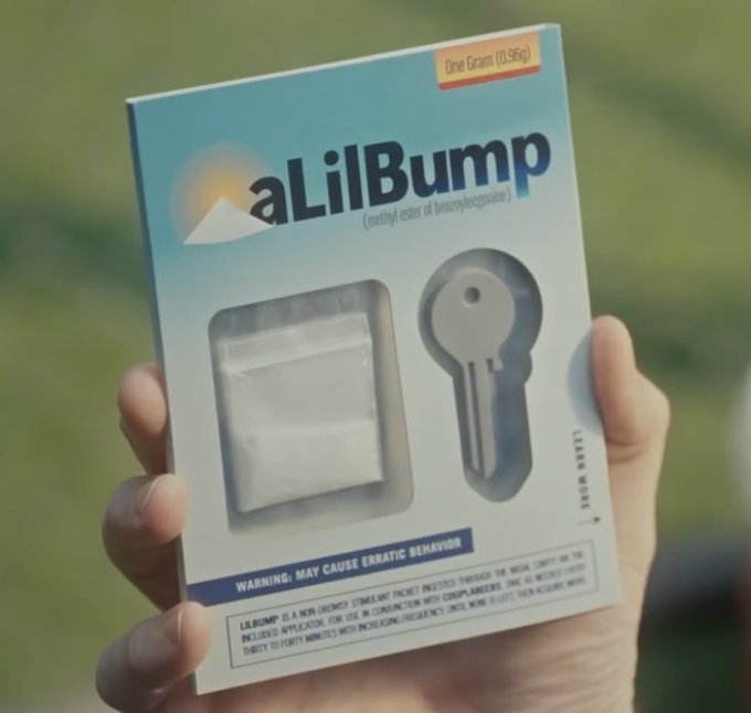 A hand holds a product package labeled 'aLilBump' (methyl ester of benzoylecgonine) with a 'WARNING: MAY CAUSE ERRATIC BEHAVIOR' notice and an image of a key and bag of white powder.