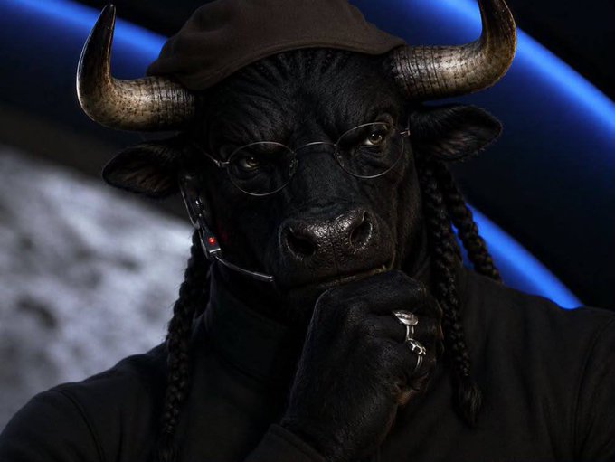 A bull wearing a headset, glasses, and beret with braids in a "thinker" pose, symbolizing the calculated confidence behind the $NIGGABULL crypto play.