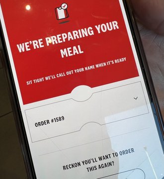 A Chick-fil-A screen displays 'WE'RE PREPARING YOUR MEAL - SIT TIGHT WE'LL CALL OUT YOUR NAME WHEN IT'S READY' for ORDER #1589.