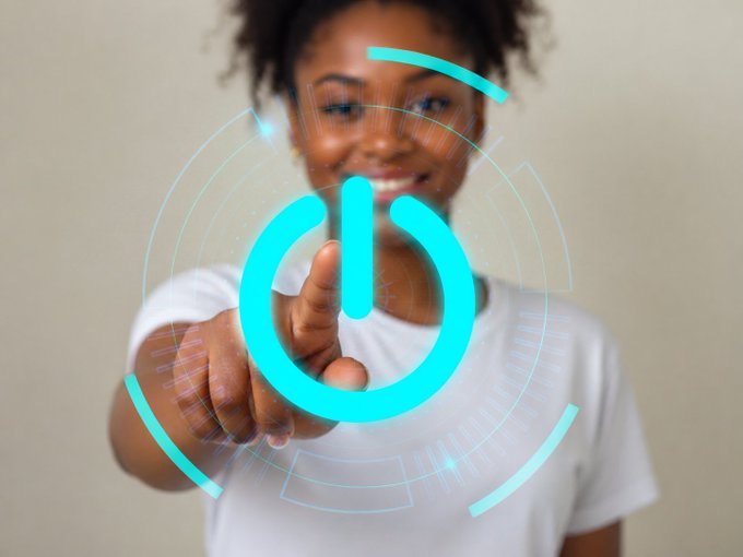 A smiling woman points forward as a glowing cyan power button icon hovers in the air over her finger, visually representing the "Weekend mode: ON" message by symbolizing the act of switching off work and powering up leisure time.