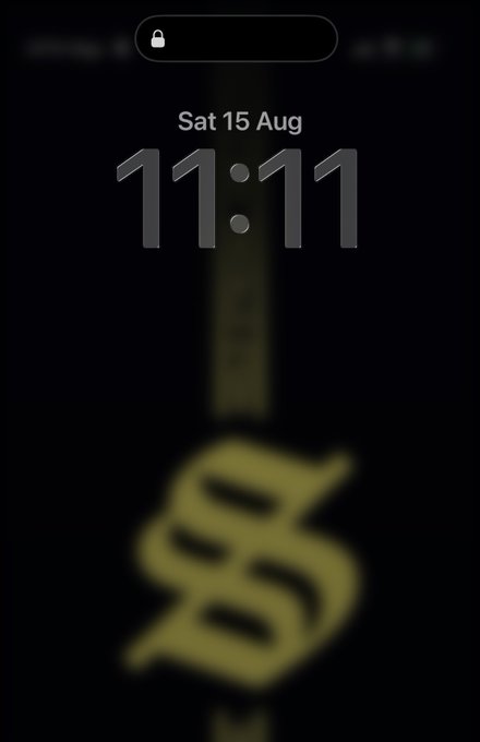 An iPhone lock screen displaying the time 11:11 on Saturday, August 15, with a blurred gold lock icon visible on a black background.