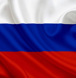 The Russian tricolor flag—featuring horizontal stripes of white, blue, and red—waves against a dark background, visually representing Russia in connection with news that Sberbank, the country's largest lender, projects crypto trading volume could reach $46.4 billion in the first year following new crypto regulations taking effect on September 1.