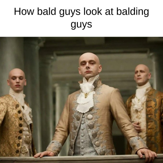 A meme with the caption "How bald guys look at balding guys" featuring three bald men dressed in ornate 18th-century aristocratic attire, including ruffled cravats and embroidered coats, standing regally in a grand interior setting.