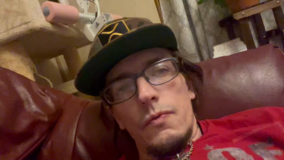 The image features a man wearing glasses, sitting comfortably on a couch with his head resting on one arm while looking at the camera. The background of the photo shows a window next to a chair, suggesting that he might be indoors or in an area with natural light. There is also a potted plant visible in the scene, adding some greenery and life to the space.

The post includes text about Japan needing Xrp to be integrated into their system correctly, which could possibly be related to the man's name or something else happening around him. The image does not provide enough information to determine if this is a relevant connection between the man and the post.
