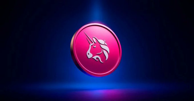 A glowing pink Unicorn coin (Uniswap/UNI logo) floats against a dark blue background with spotlight illumination, symbolizing the token's scarcity-driven upside potential highlighted in Standard Chartered's bullish $100 price target.