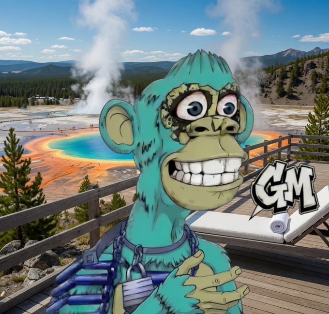 A cartoon turquoise monkey wearing chains flashes a wide grin in front of Yellowstone's vibrant Grand Prismatic Spring, with "GM" graffiti-style text beside it, matching the cheerful "Gm Have a Fantastic Saturday" post.
