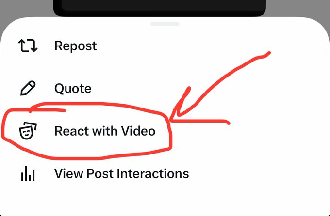 The image shows a social media app screen with a red highlight indicating that the viewer should react with a video. The app's interface displays various buttons for interacting with posts, such as liking, sharing, and reacting with videos. The focus of the image is on the reaction button, which is highlighted in red to draw attention to it. This feature encourages users to engage with content by liking or sharing posts that include reactions, potentially increasing the visibility and reach of the post.