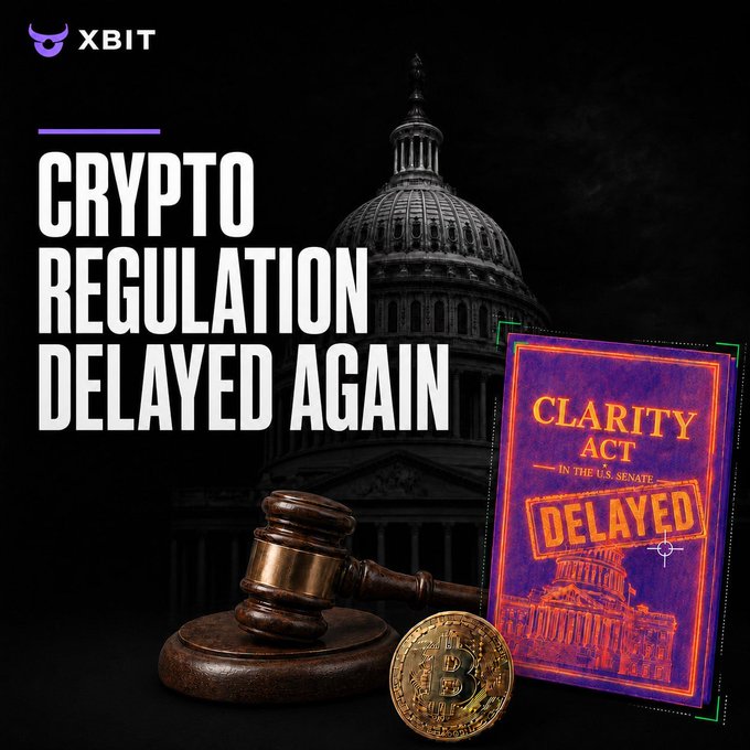 A news graphic from "XBIT" showing a gavel, Bitcoin coin, and US Capitol dome with the headline "CRYPTO REGULATION DELAYED AGAIN" and a book labeled "CLARITY ACT IN THE U.S. SENATE DELAYED".