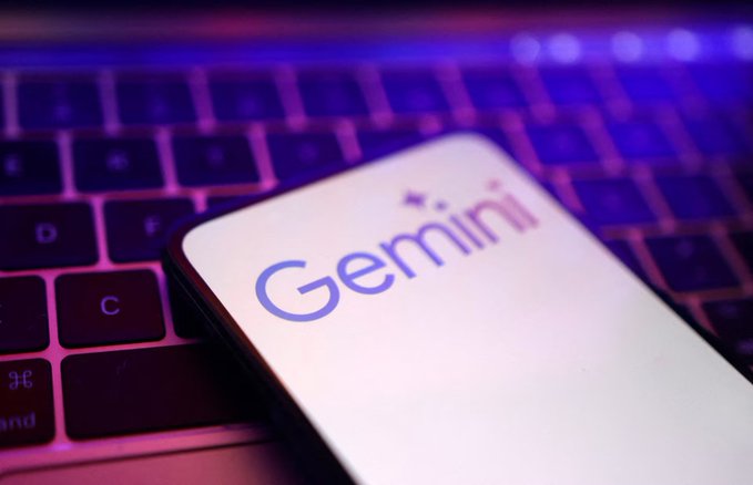 A smartphone displaying the Gemini logo rests on a laptop keyboard, illustrating the crypto exchange's logo in a tech setting. The image visually reinforces the post about Gemini expanding its Bitcoin treasury holdings to over 5,500 BTC.